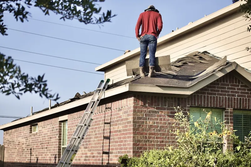 Professional roofer working on a residential roof in Battlefield